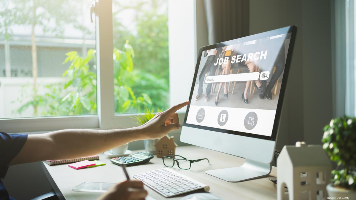 a women pointing finger towards laptop scree